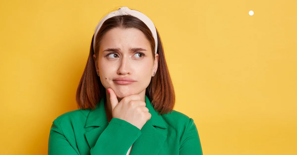 Confused woman thinking against a yellow background, representing uncertainty about technical SEO.